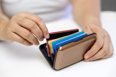 Close up of hands choosing and picking a credit card.の写真素材