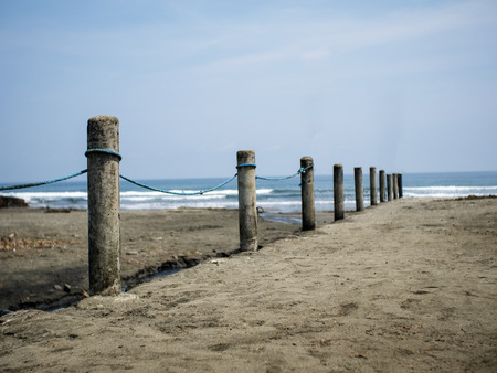 Rows of cement barrier or fence serves as a boundary or borderline of beach property.