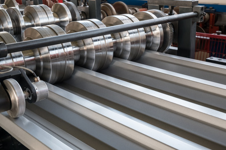 Roll forming machine shaping corrugated roof profileの写真素材