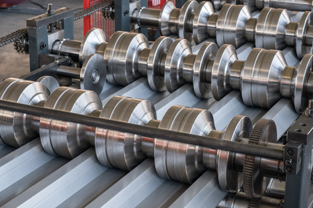 Roll forming machine shaping corrugated roof profileの写真素材