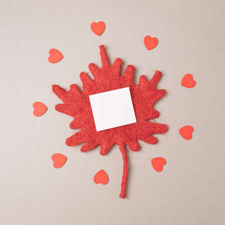 Romantic red elements layout with hearts on a beige background. Minimal valentines conceptの写真素材