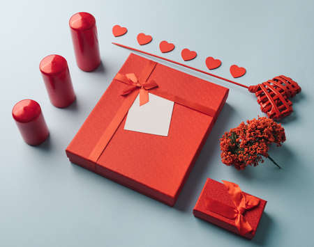 Red gift elements arranged on a light blue background. Valentines minimal conceptの写真素材