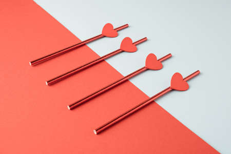 Love celebration drinking straws minimal layout on a geometric pastel background.の写真素材