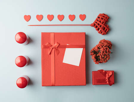 Red gift elements arranged on a light blue background. Valentines minimal conceptの写真素材