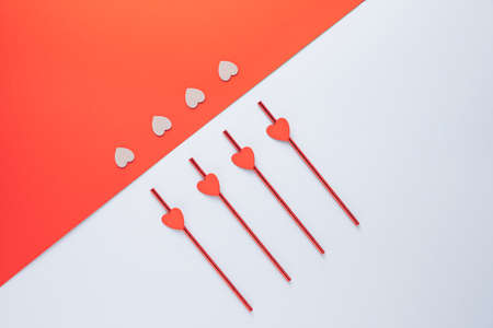 Heart elements arranged on a pastel blue and red background. Minimal Valentines celebration concept.の写真素材
