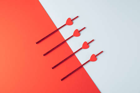 Heart elements arranged on a pastel blue and red background. Minimal Valentines celebration concept.の写真素材