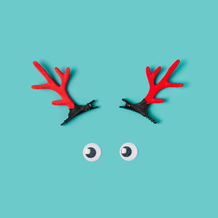 Minimal reindeer ornaments layout on a pastel blue background. Christmas minimal conceptの写真素材
