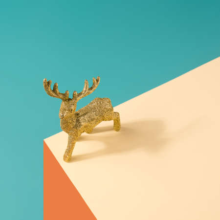 Reindeer decoration figurine on a geometric pastel background. Minimal winter holiday conceptの写真素材
