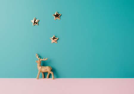 Golden winter ornaments on a two tone pastel background. Winter holidays minimal backgroundの写真素材