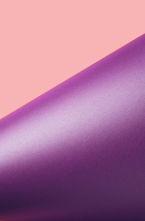 Lavender colored paper turned to expose pastel pink surface bellow. Minimal violet backgroundの写真素材