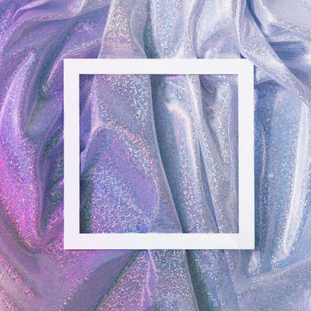 Magenta and blue gradient fabric with metallic shine and frame on top. Future conceptual flat lay.の写真素材