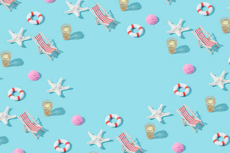Summer vacation beach items arranged on a pastel blue background. Summertime relaxation funny...