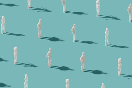 Standing human figurines on a pastel blue background. Transhumanism minimal pattern.の写真素材