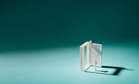 Man plastic figure standing in frond of the open door. Solution, problem solving minimal background.の写真素材