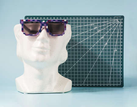White marble head with sunglasses and geometric board in the background. Futuristic vacation concept.の写真素材