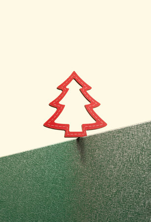 Red Christmas tree ornament on the edge of the green stand. Merry Christmas minimal concept.の写真素材