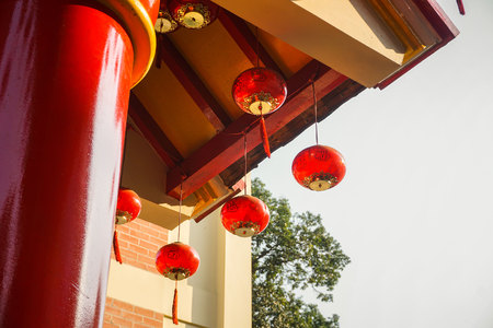 beautiful red lamp on the temple with sunlight bright come from top