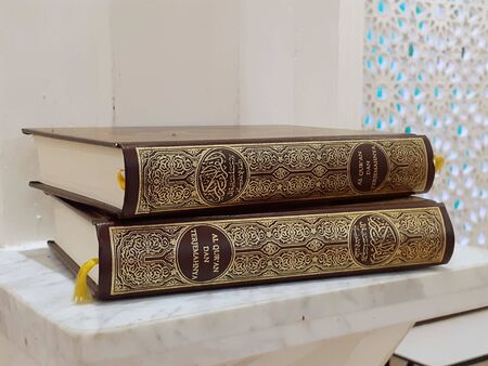 PEKALONGAN, INDONESIA - MARCH 11, 2019: quran stack with golden curve color and marble floor - photoのeditorial素材