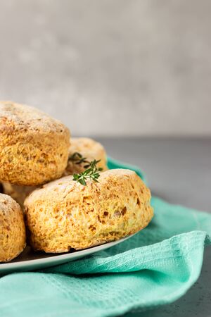 Homemade cheese buns or scones and thyme on a gray ceramic plate.の写真素材