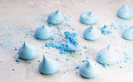Small blue meringues with crumbles on light gray stone background.の写真素材