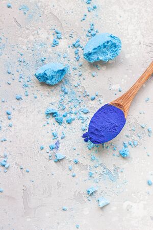 Blue Spirulina (Phycocyanin) powder and crumbled meringue. Healthy dietary supplement. An intense blue natural pigment derived from blue-green algae. Superfood and vegan food concept.の写真素材