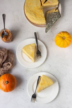 Pumpkin cheesecake with caramel sauce, light gray stone background. Selective focus.の写真素材