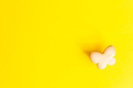 Easter cookies on yellow paper background. Easter symbols and traditions. Butter and sugar cookies.の写真素材