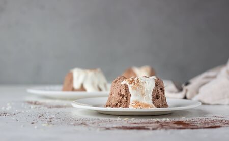 Chocolate cottage cheese dessert decorated with white chocolate glaze, coconut flakes and cocoa...