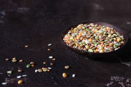 White rice and different types of lentil, dark brown concrete background. Agricultural product...