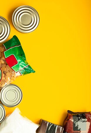 Food donations for quarantine isolation period on yellow background. Food delivery, coronavirus quarantine. Flat lay composition, copy space.の写真素材