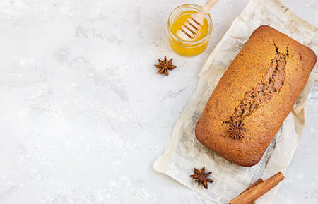 Spicy honey cake with cinnamon and anise star on light gray background. Honey cake for Rosh...