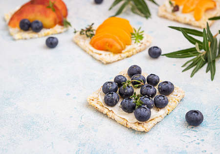 Fruit dessert sandwiches with cream cheese. Delicious healthy breakfast toasts with cream cheese,...