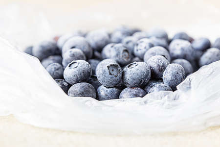 Frozen blueberries in transparent plastic bag. Close up. Concept of healthy eating.の写真素材