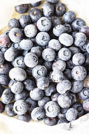 Frozen blueberries in transparent plastic bag. Close up. Concept of healthy eating.