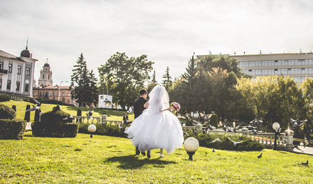 Newlyweds running on the centre of Minskの写真素材