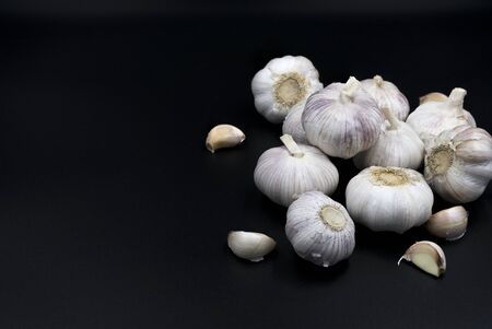 Raw garlic isolated on black backgroundの写真素材