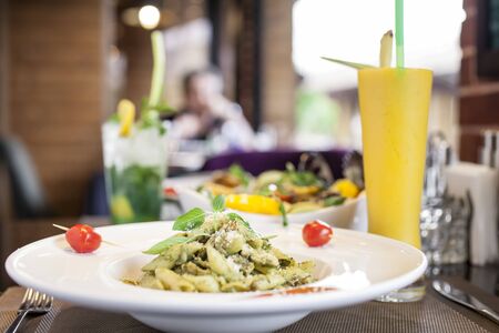Italian penne pasta served by orang juiceの写真素材