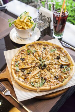 An Italian pizza with French friesの写真素材