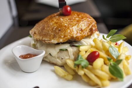 A juicy yummy cheese burger with, French fries