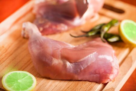A slice of chicken leg with lemon and peppersの写真素材