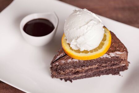 Soft chocolate cake and a scoop of vanilla ice creamの写真素材