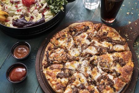 Delicious pizza with saladの写真素材