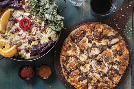 Delicious pizza with saladの写真素材