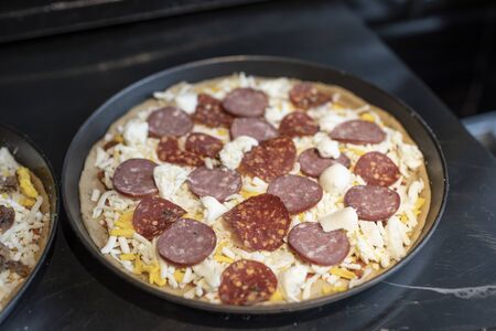 the salami pizza before cookingの写真素材
