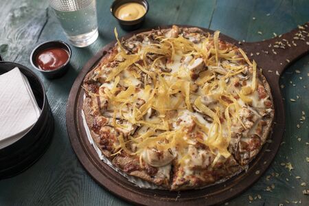 Alfredo Chicken Pizza And fried potatoesの写真素材