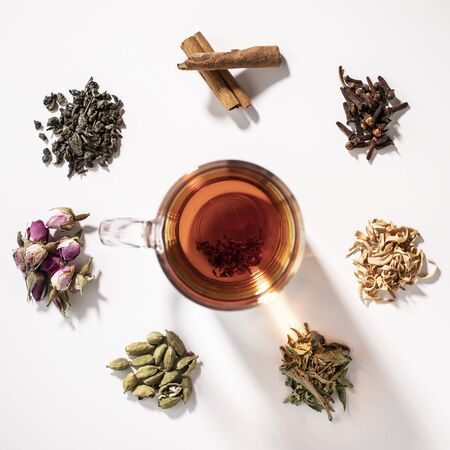 a cup of tea with colorful kinds of flowers and herbsの写真素材