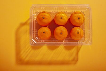 Oranges in a plastic containerの写真素材