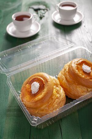 Delicious cream puff in plastic containerの写真素材