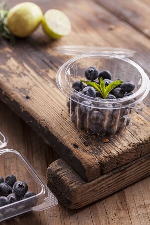 Fresh blueberries in a plastic containerの写真素材