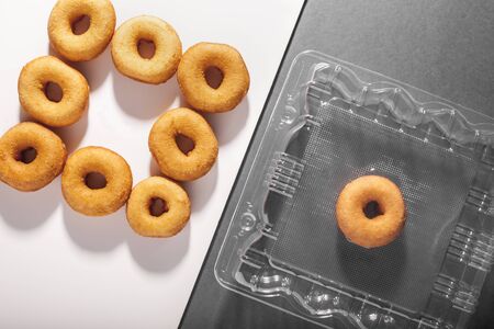 Delicious donuts in a plastic containerの写真素材